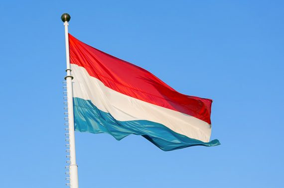 Flag of Luxembourg waving in the wind against blue sky (123rf.com)
